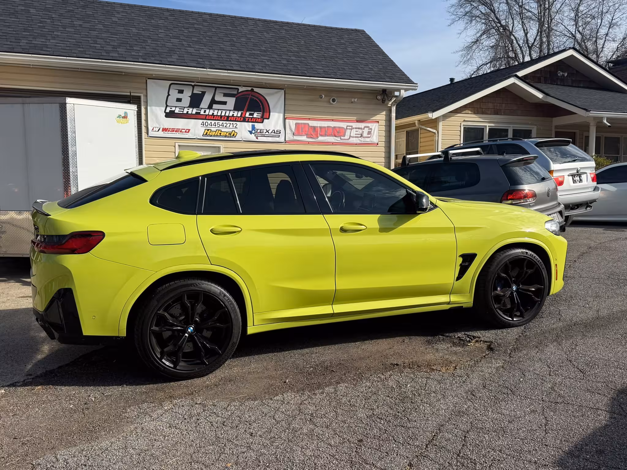 lime green bmw x4m receiving preventative maintenance at 875 Performance Marietta GA