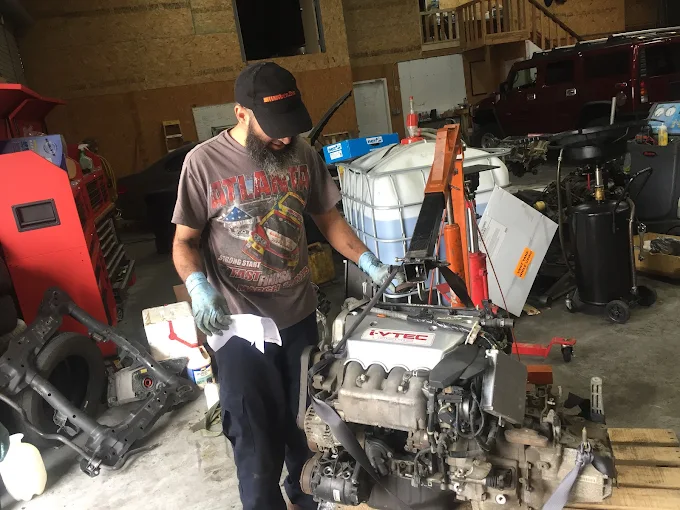 Tarek performing engine swap at 875 Performance Marietta GA